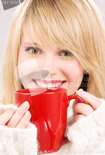 Image of happy teenage girl with red mug