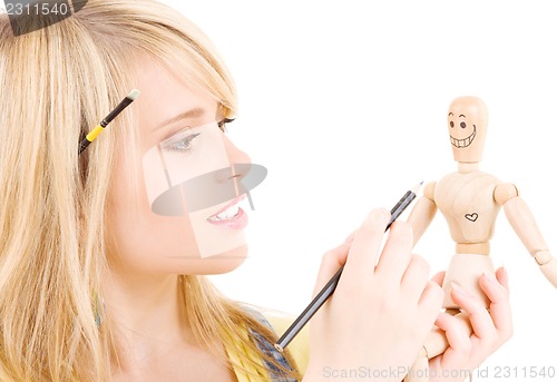 Image of happy teenage girl with wooden model dummy