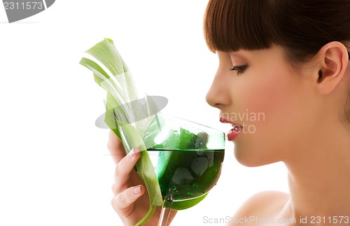 Image of woman with green leaf and glass of water