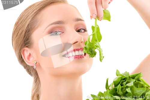 Image of happy woman with spinach