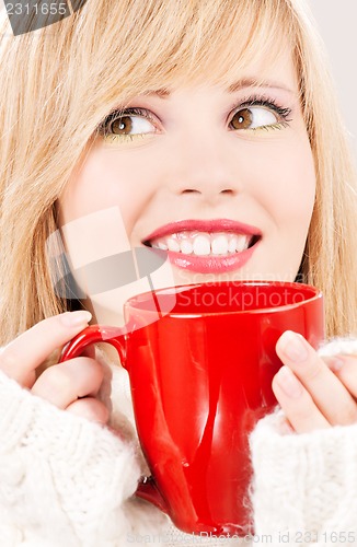 Image of happy teenage girl with red mug