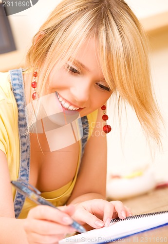 Image of teenage girl with notebook and pen