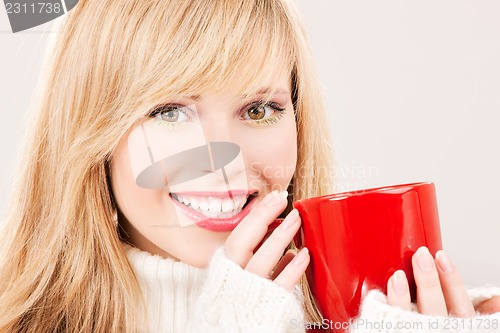 Image of happy teenage girl with red mug