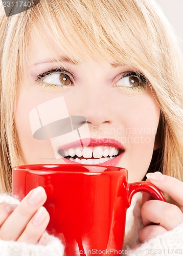 Image of happy teenage girl with red mug