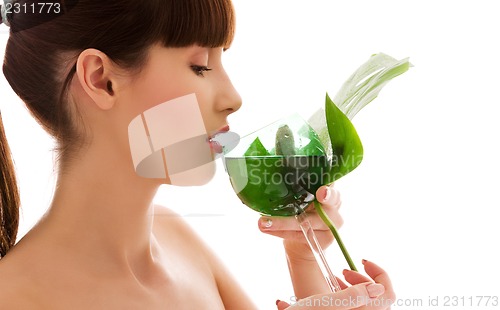 Image of woman with green leaf and glass of water