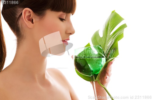 Image of woman with green leaf and glass of water