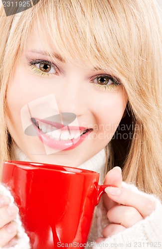 Image of happy teenage girl with red mug