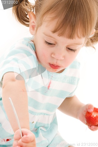 Image of little girl with strawberry