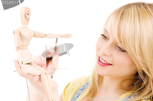 Image of happy teenage girl with wooden model dummy