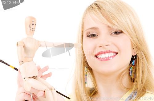 Image of happy teenage girl with wooden model dummy