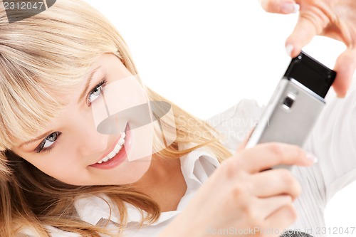 Image of happy woman using phone camera