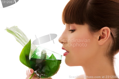 Image of woman with green leaf and glass of water