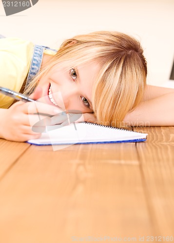 Image of teenage girl with notebook and pen