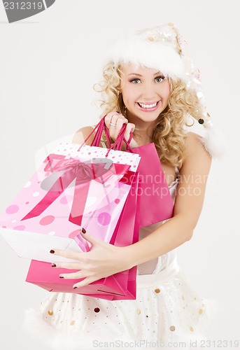 Image of santa helper with pink shopping bags