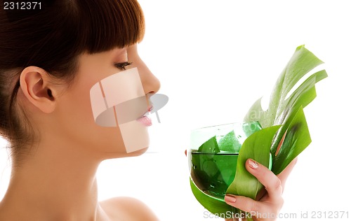 Image of woman with green leaf and glass of water