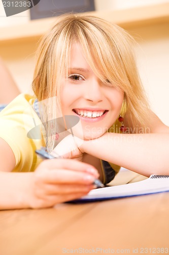 Image of teenage girl with notebook and pen