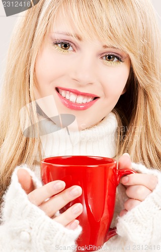Image of happy teenage girl with red mug