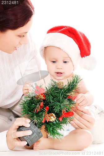 Image of baby and mother with christmas gifts