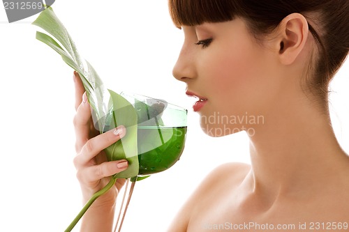 Image of woman with green leaf and glass of water