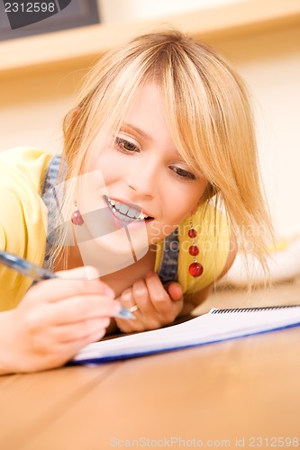 Image of teenage girl with notebook and pen