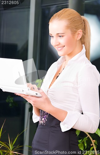 Image of happy businesswoman with laptop computer