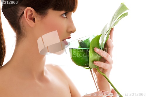 Image of woman with green leaf and glass of water