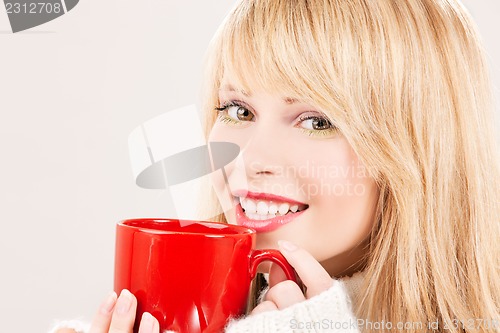 Image of happy teenage girl with red mug