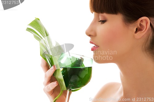 Image of woman with green leaf and glass of water