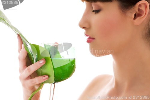 Image of woman with green leaf and glass of water