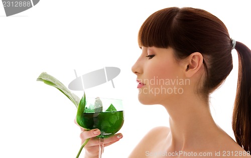 Image of woman with green leaf and glass of water