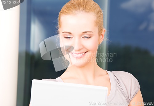 Image of happy businesswoman with laptop computer