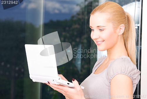 Image of happy businesswoman with laptop computer