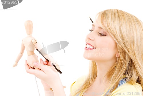 Image of happy teenage girl with wooden model dummy