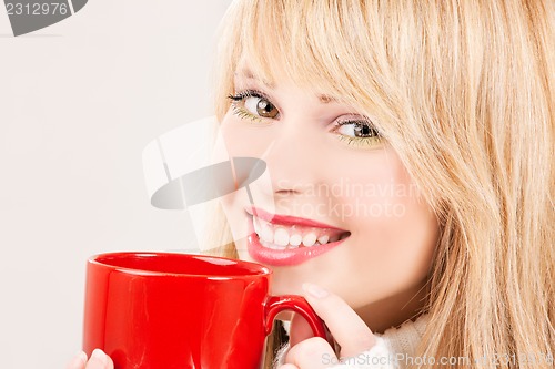 Image of happy teenage girl with red mug