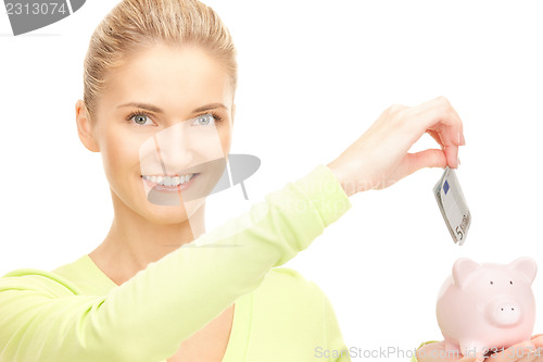 Image of woman with piggy bank and money