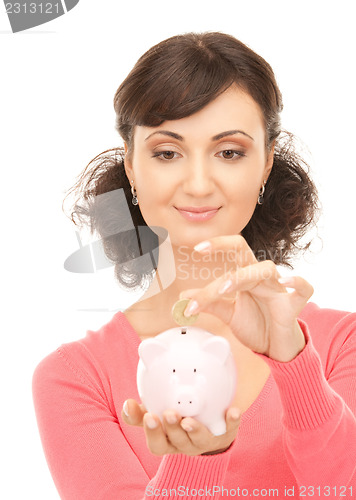 Image of lovely woman with piggy bank and money