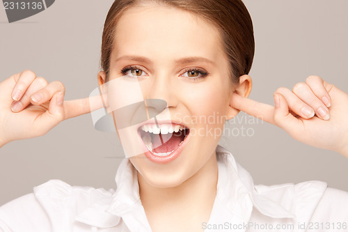 Image of woman with fingers in ears