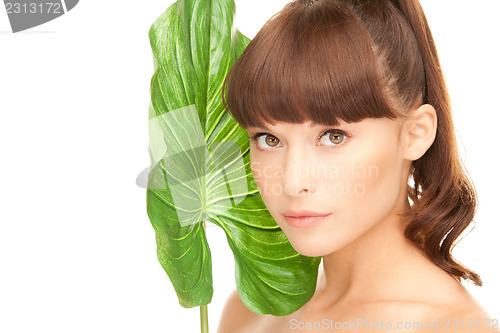 Image of woman with green leaf