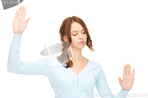 Image of businesswoman working with something imaginary