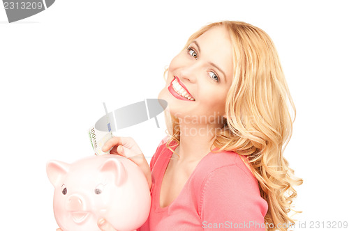 Image of lovely woman with piggy bank and money