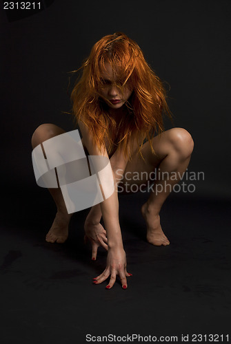 Image of naked redhead woman over black