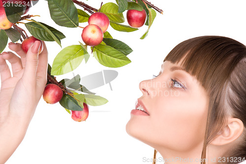 Image of lovely woman with apple twig