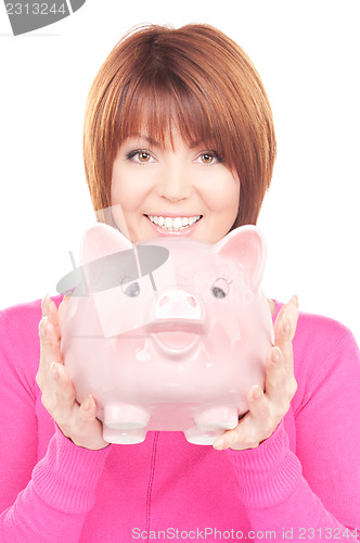 Image of lovely woman with piggy bank  