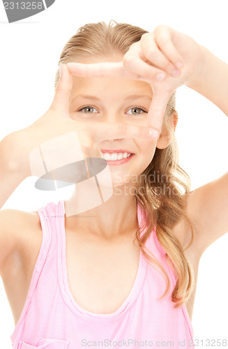 Image of pretty girl creating a frame with fingers