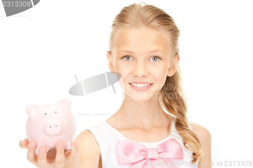 Image of lovely teenage girl with piggy bank