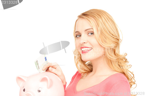 Image of lovely woman with piggy bank and money