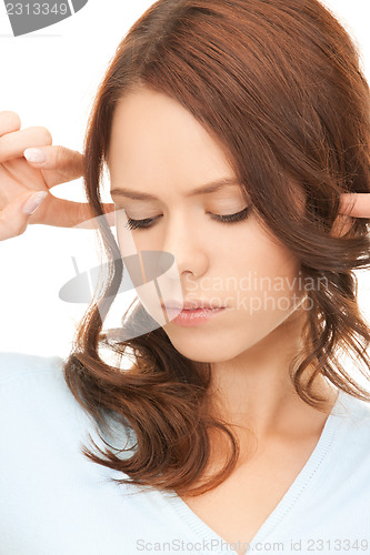 Image of woman with fingers in ears