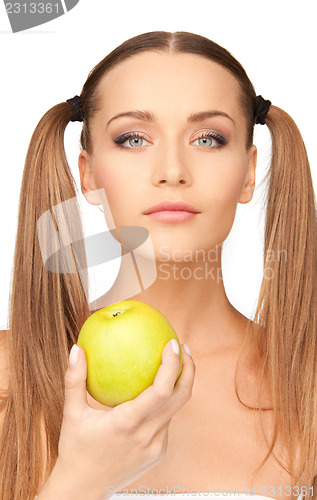 Image of young beautiful woman with green apple