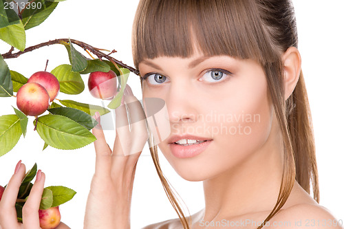 Image of lovely woman with apple twig