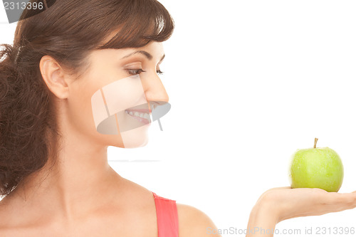 Image of young beautiful woman with green apple